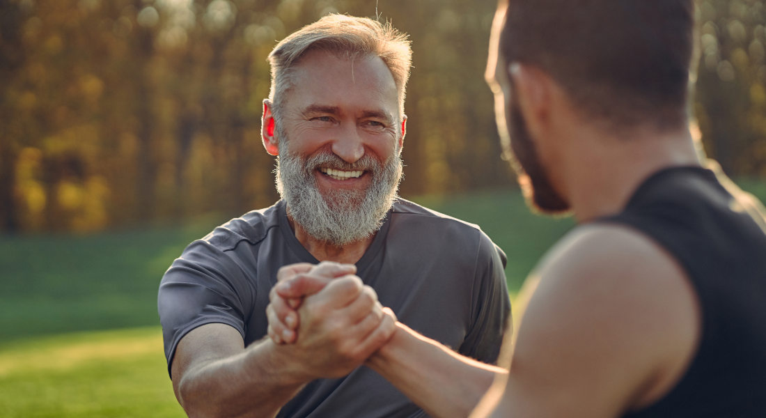 two guys shaking hands outside