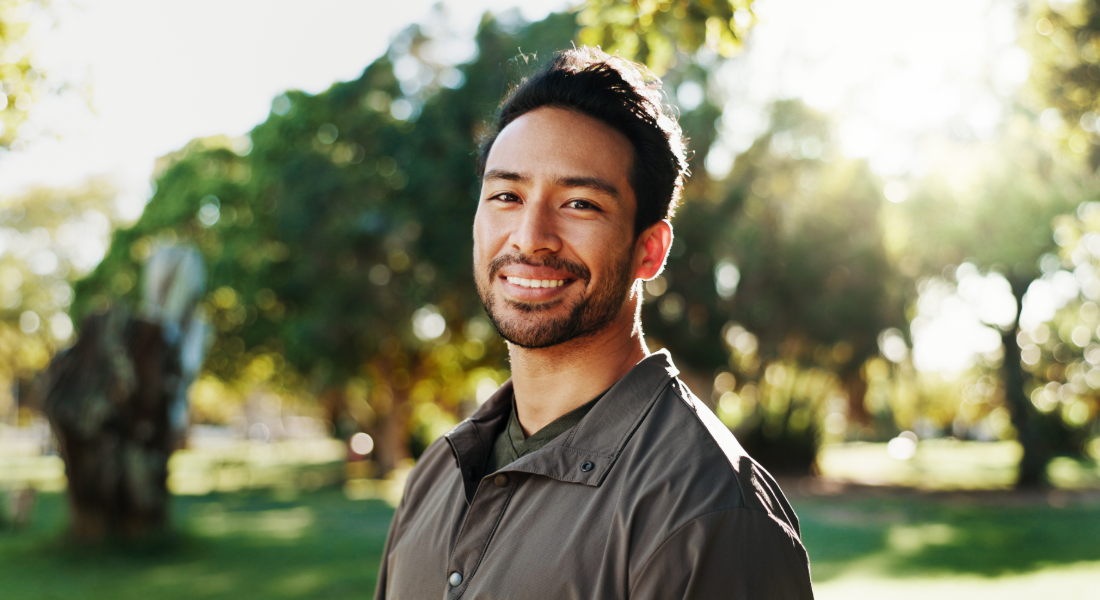 portrait photo of a smiling man outside